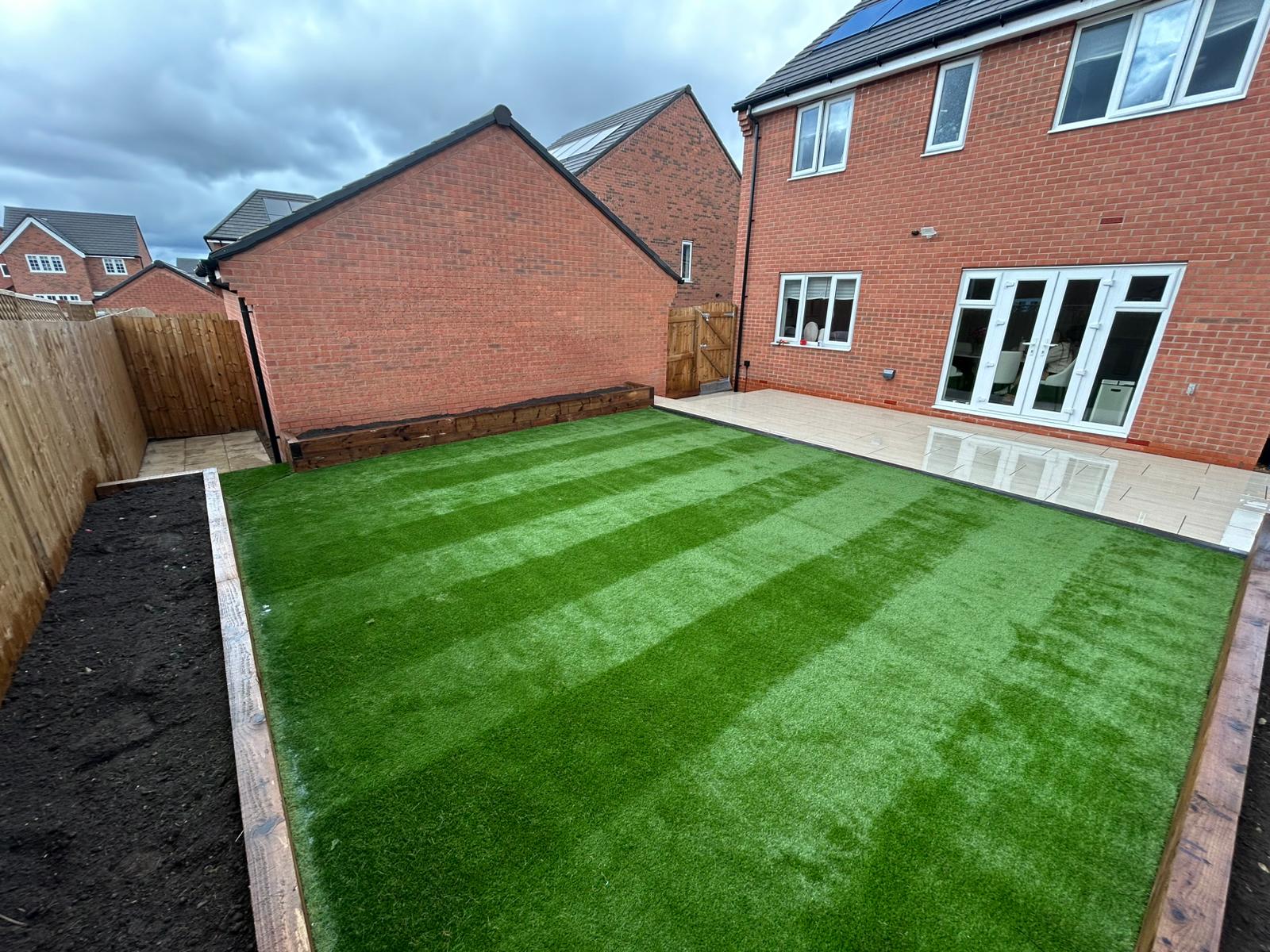Striped artificial grass with sleeper borders